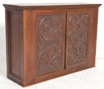 A Victorian 19th century carved oak wall cupboard. Of rectangular form having twin carved panel