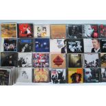 A collection of music compact discs featuring various artists to include The White Stripes, Miles