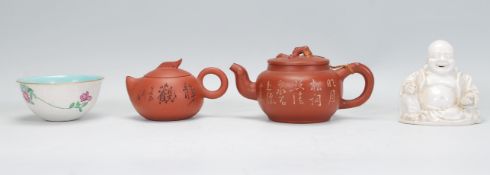 A collection of mixed 20th Century Chinese ceramic wares to include a white glazed laughing happy