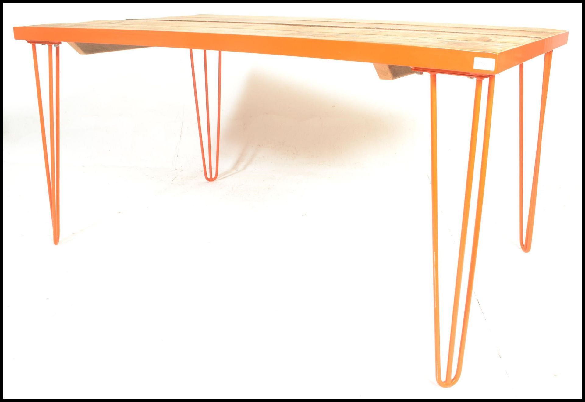 A modernist contemporary metal framed refectory dining table raised on hairpin upright supports in