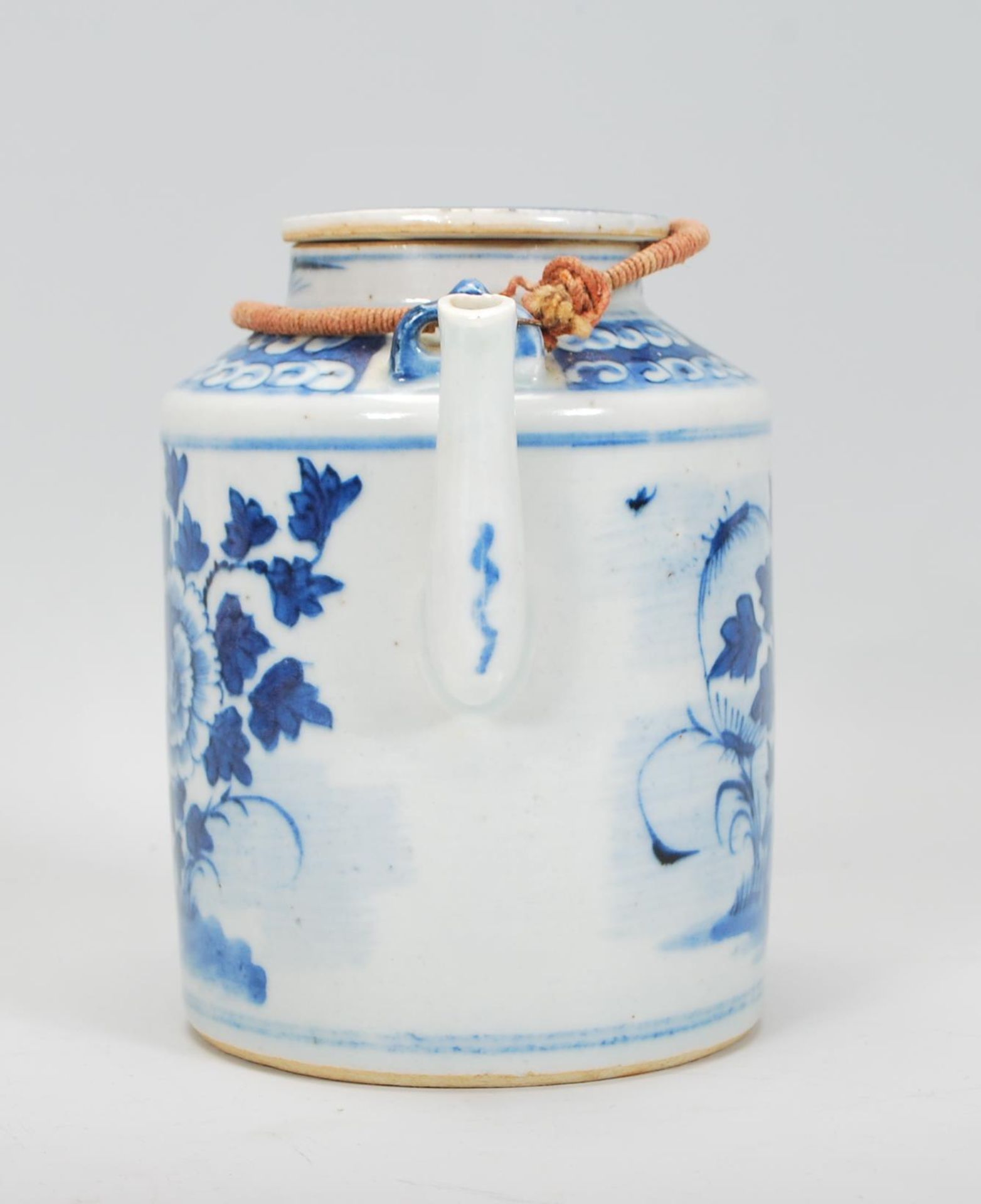 A 19th Century Chinese porcelain tea pot of tubular form hand painted in blue and white with peonies - Image 2 of 7