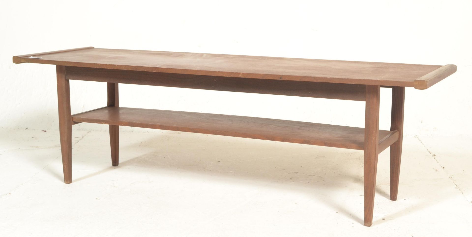 A 1960's retro vintage teak wood long john two tier coffee table having a long rectangular top