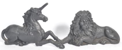A pair of  cast iron boot scrapers depicting a lion and a unicorn. Front facing relief figures
