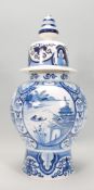 A large  blue and white delft lidded jar of bulbous form with typical Chinese decoration to the