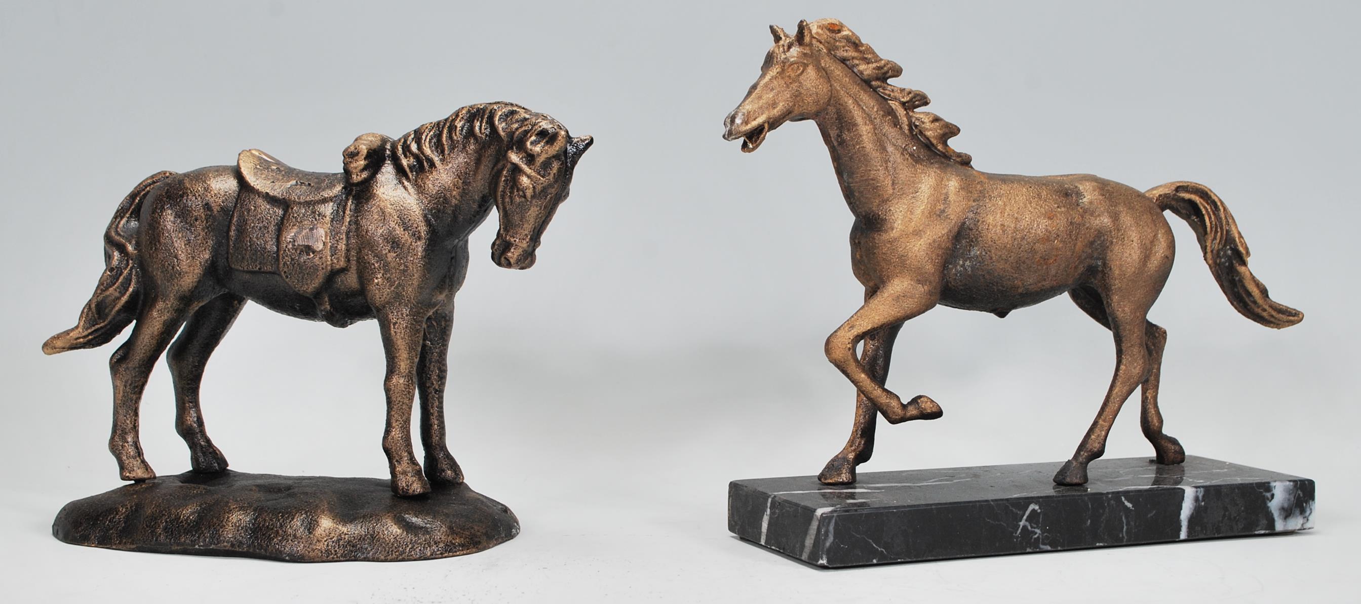 Two cast iron figurines of horses to include one of a running stallion raised on a marble plinth