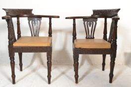 A pair of Victorian 19th century carved oak corner chairs. Raised on turned legs with drop in faux