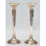 A pair of 1920's Art Deco Saunders & Shepherd silver hallmarked candlesticks raised on round bases
