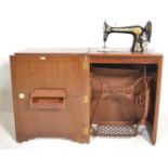 A 1930's Art Deco oak Singer Sewing machine cabine