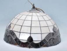 A contemporary antique style stained and leaded glass ceiling lamp shade of domed form being in