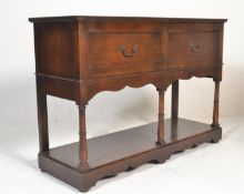 A Georgian revival oak cottage dresser, the open dresser and rack, with two fixed shelves, the
