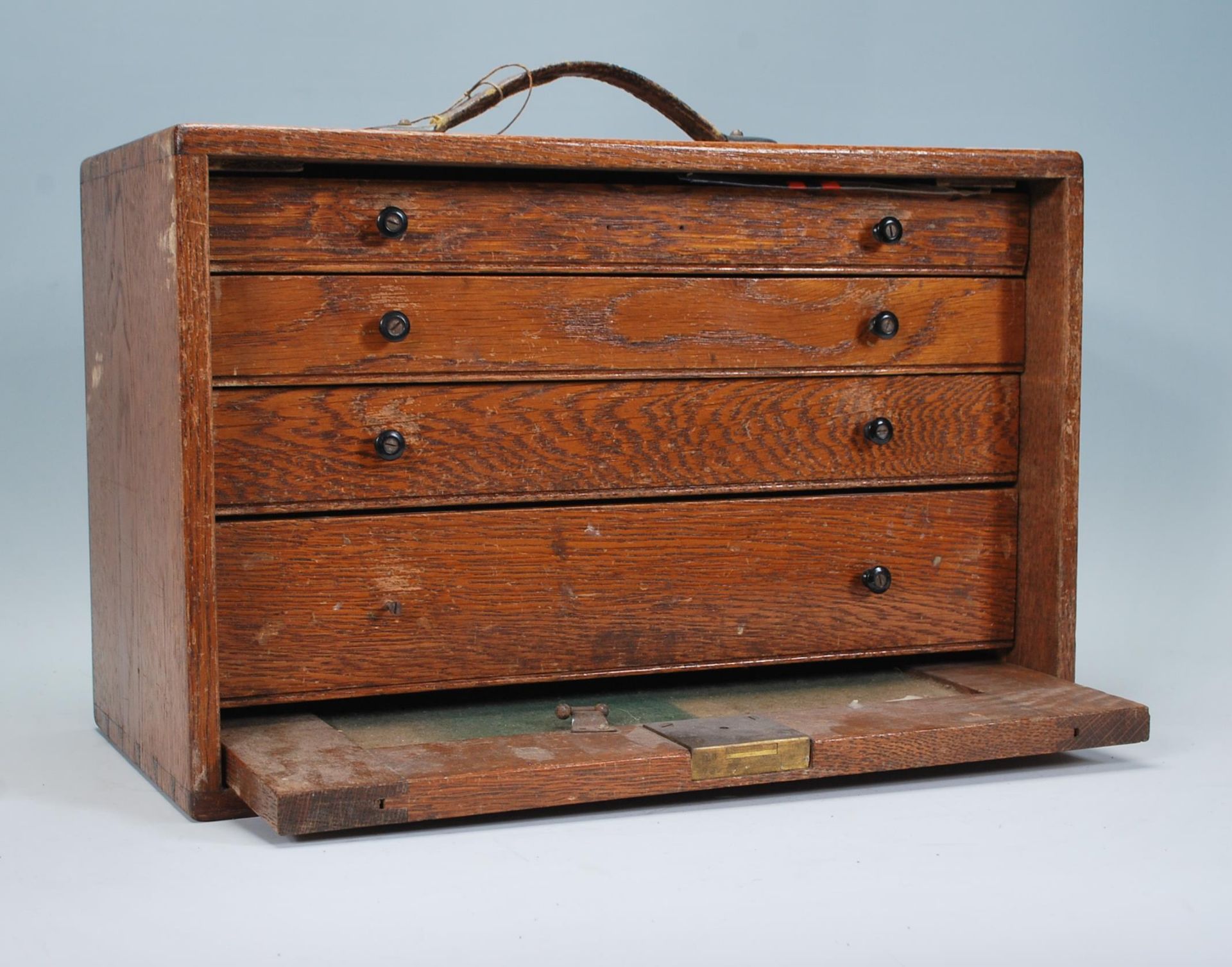 A vintage 20th Century oak engineers case, fall front revealing lined drawers containing engineers