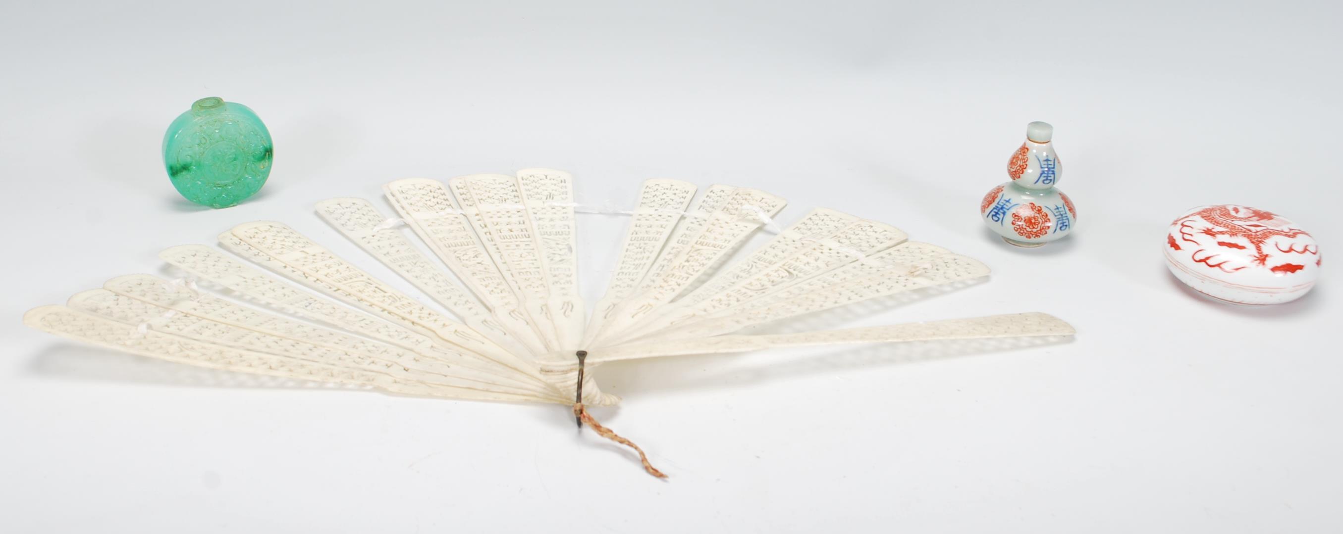 A collection of vintage Chinese items to include a carved fret pierced hand fan, a green jade