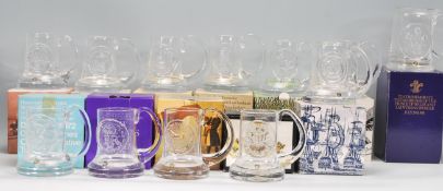 A collection of Dartington Crystal commemorative glassware tankards designed by Frank Thrower. The