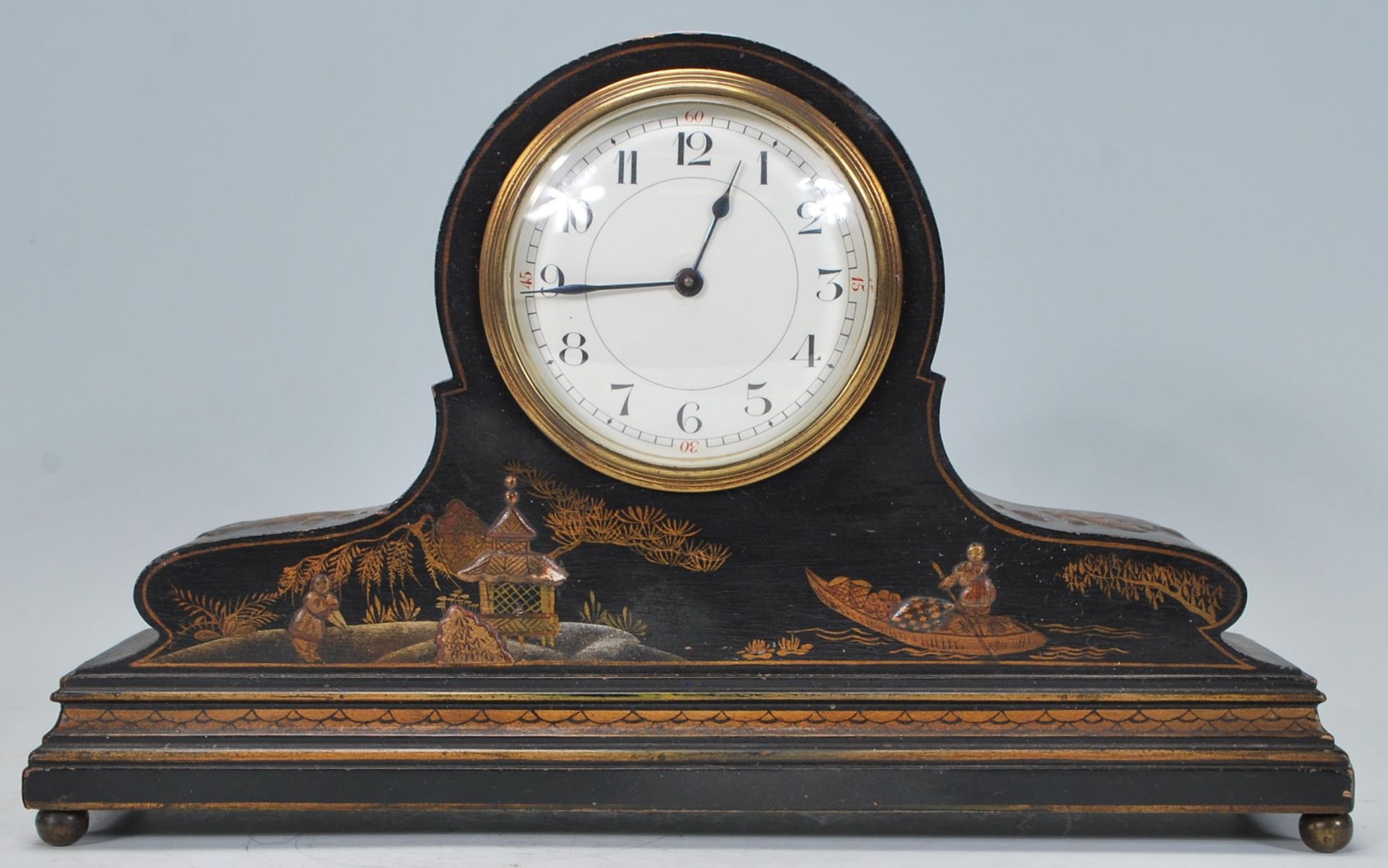 An early 20th century Japanned black lacquer and chinoiserie decorated dome top mantel clock in