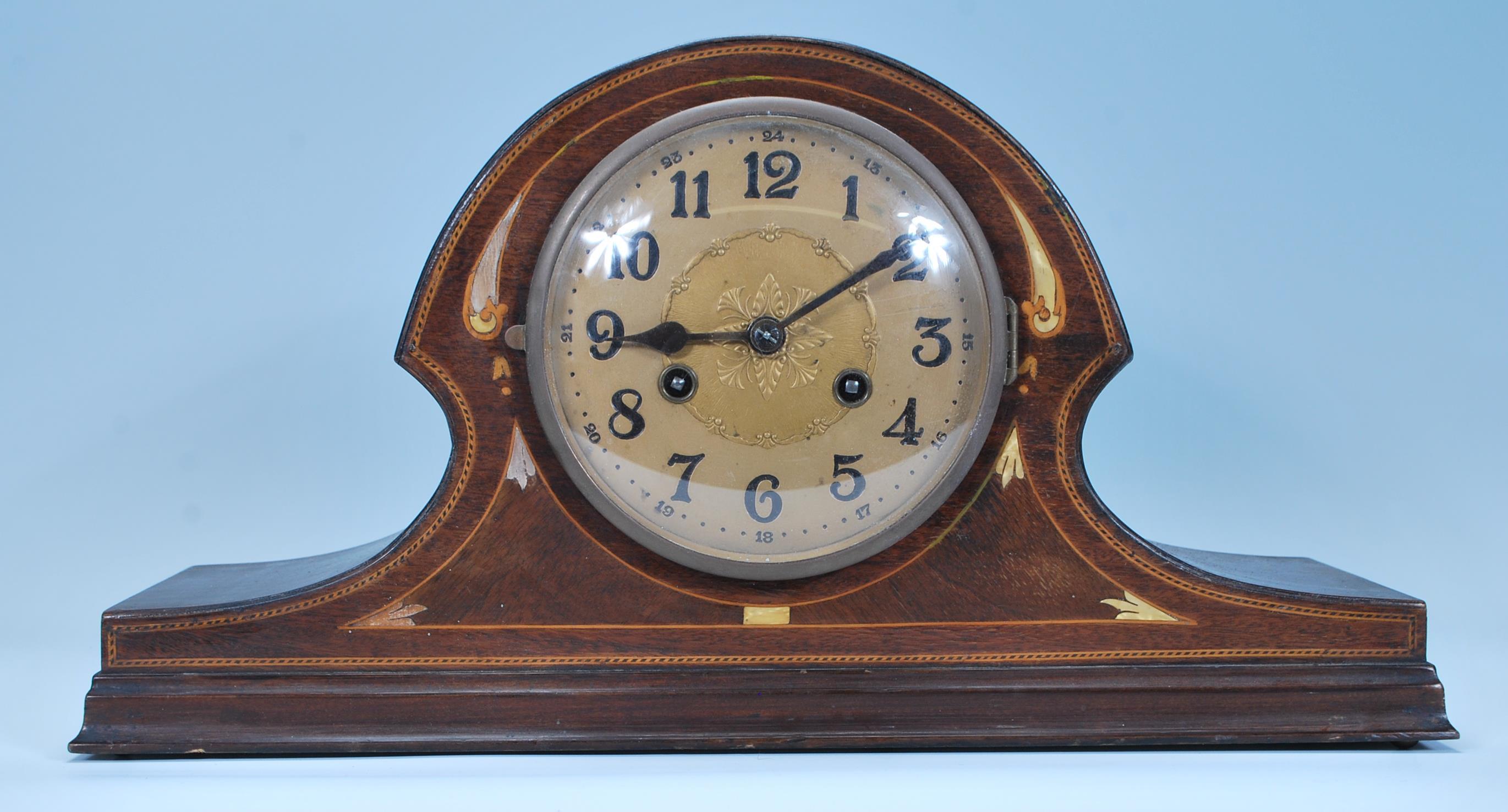 An early 20th Century Edwardian Napoleons hat mantel clock having satin wood and mother of pearl