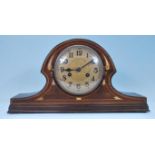 An early 20th Century Edwardian Napoleons hat mantel clock having satin wood and mother of pearl