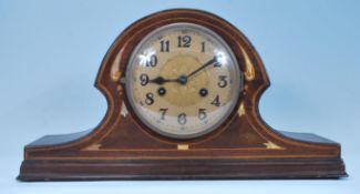 An early 20th Century Edwardian Napoleons hat mantel clock having satin wood and mother of pearl