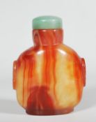 A Chinese carved agate scent bottle, the body made from red veined stone with carved decorative