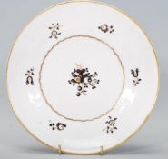 A 19th Century believed Pinxton porcelain plate having hand painted gilt and black floral decoration