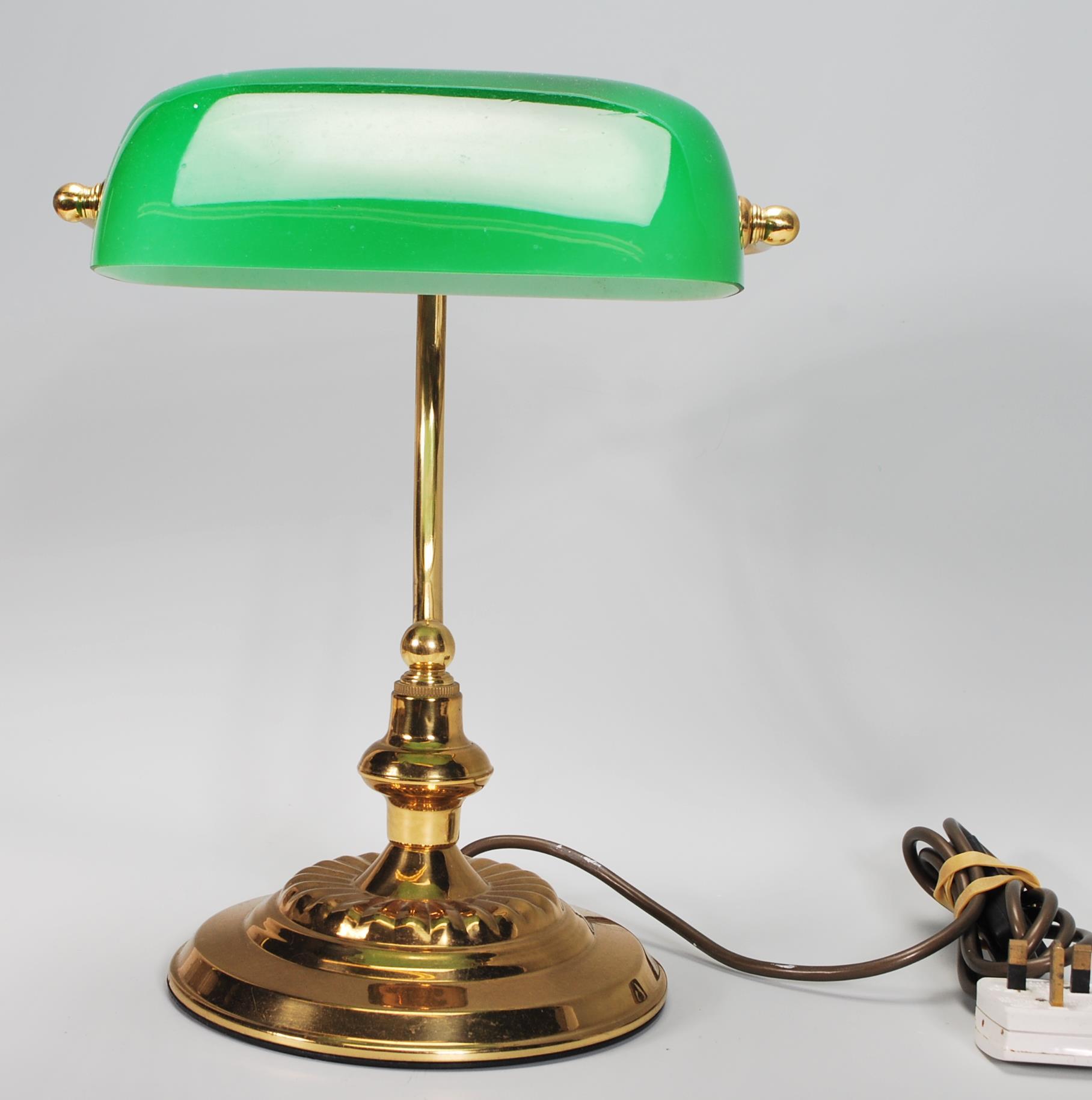 A vintage 20th Century bankers desk lamp having an adjustable green glass shade raised on a brass - Image 2 of 5