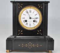 A Victorian 19th century slate mantel clock with the dial being marked for Paris. Inset brass 8