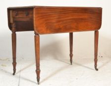 A 19th century George III mahogany pembroke table. Raised on turned legs with castors having