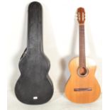 A 20th Century Spanish six string acoustic guitar having inlaid decoration to the sound hole,
