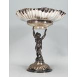 An early 20th Century silver plate tazza centerpiece having a round crimped flared rim with embossed