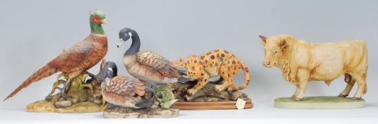 A selection of 20th Century ceramic animals to include a Akita ring-necked pheasant, bull and