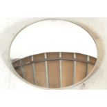 A vintage 20th Century convex security wall mirror, adjustable wall bracket to rear with applied