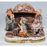 A 20th century Capodimonte of Naples ceramic group ornament entitled 'fireside' depicting a family