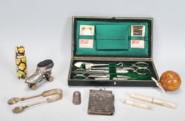 A collection of sewing items to include an early 20th Century leather cased sewing kit, a tape