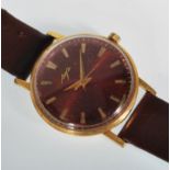 A vintage Russian Luch gentleman's gold plated wrist watch having a round red face with gilt baton