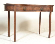 A 20th Century walnut kidney shaped writing table. Raised on four straight legs with two central