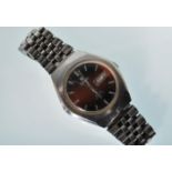A vintage gentleman's F77 stainless steel cased automatic wrist watch having a round red enamelled