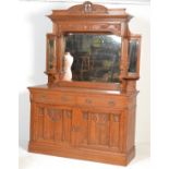 A late Victorian oak Arts and Crafts mirror backed sideboard the upper section comprising central