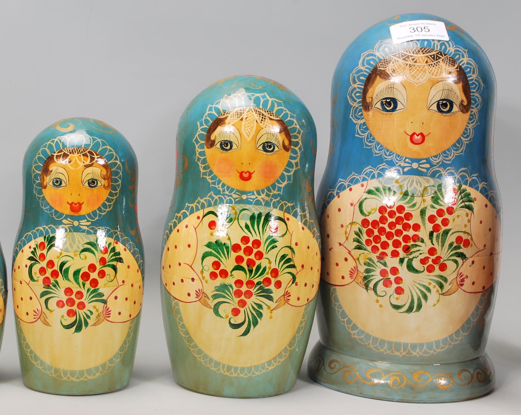 A collection of Russian ornaments to include a large set of russian dolls beung hand painted with - Image 7 of 9