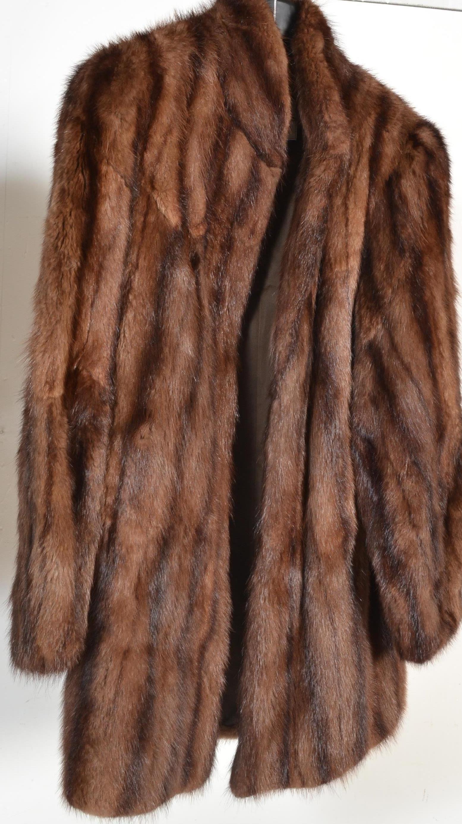 A vintage mid Century ladies beaver fur coat having a short collar with silk lined interior