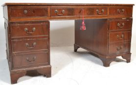 An early 20th Century antique twin pedestal desk, each pedestal having three drawers with swing