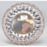 A 20th Century Portuguese silver plate of round form having reeded and scrolled decoration in high
