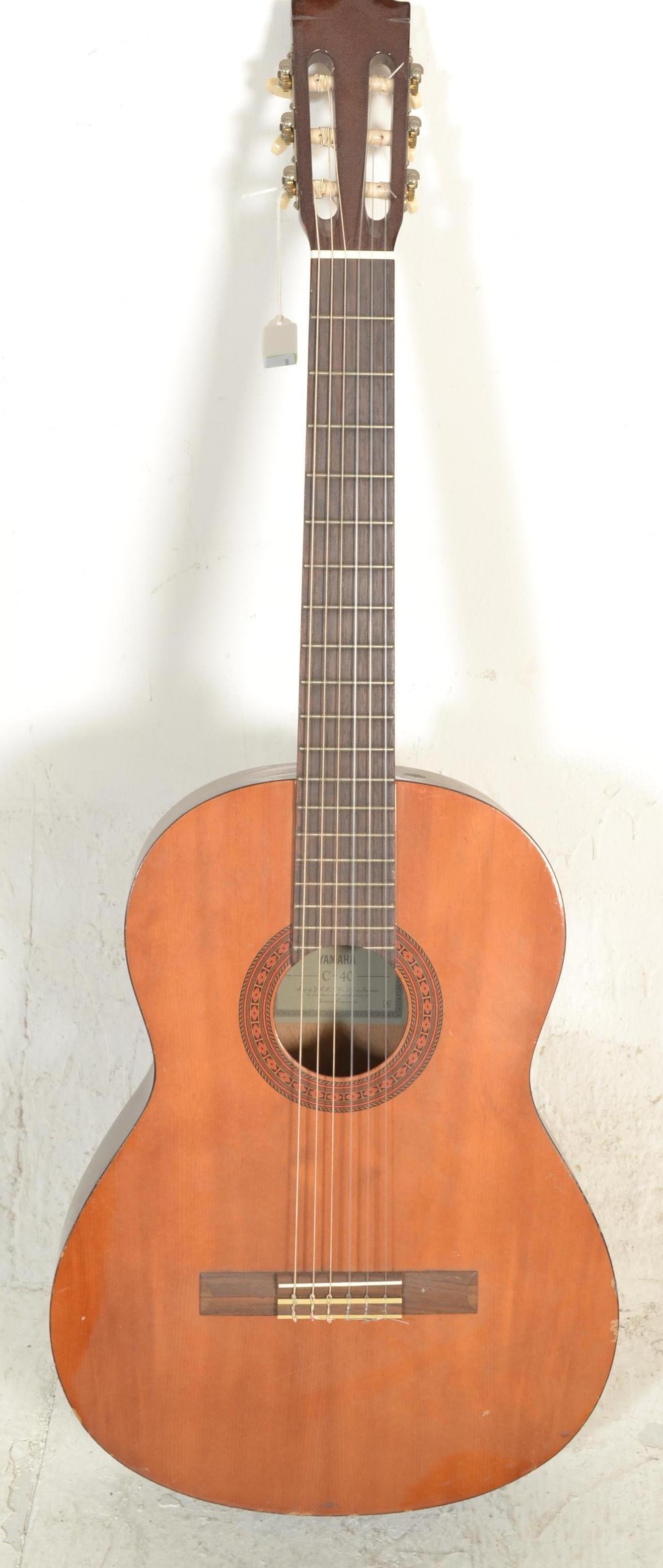 A 20th Century six string acoustic Yamaha C-40 Spanish style guitar, applied paper label to inside.