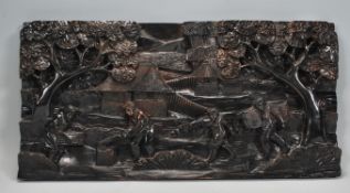 A believed early 20th century Asian carved hardwood wooden plaque. Carved into relief with scenes of