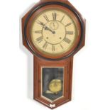 A mahogany cased Ansonia wall clock, made in Brooklyn, of octagonal frame form set around a white