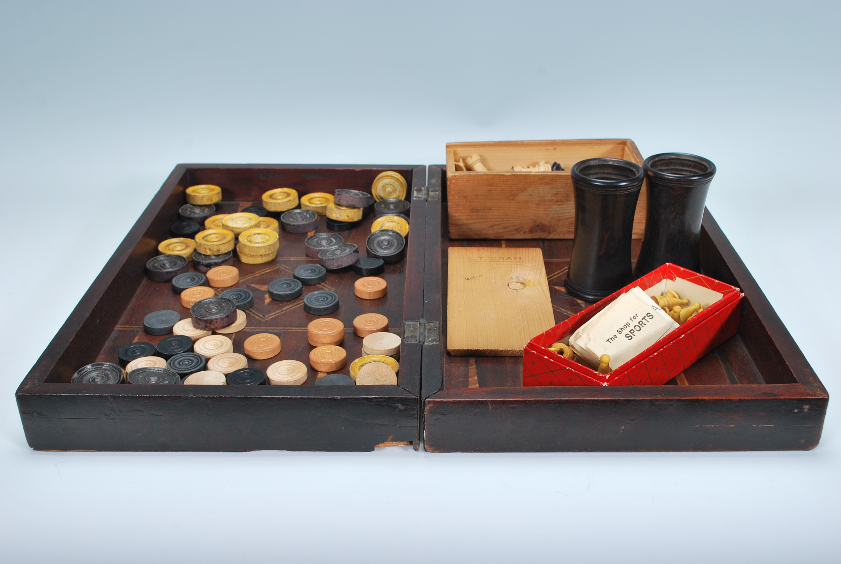 A 19th Century games compendium, in chequerboard case, the case opening up to become a backgammon