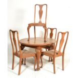 An Edwardian oak oval wind out dining table together with a single leaf extension having a set of