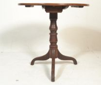 A George III mahogany tripod table, with circular dished top raised on a turned column with three