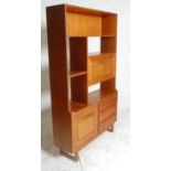 A retro mid 20th Century teak wood room unit having fitted shelves above a configuration of three