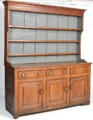 An 18th century George III country dresser. The base comprising a series of short drawers over