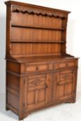 A good Jacobean revival Ipswitch oak Welsh dresser, Raised on squared legs with carved double door
