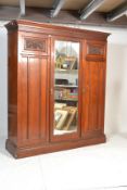 A late Victorian / Edwardian walnut Arts and Crafts triple wardrobe compactum, central bevelled